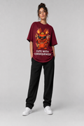 Person wearing a maroon t-shirt with a graphic design and text, standing against a plain background